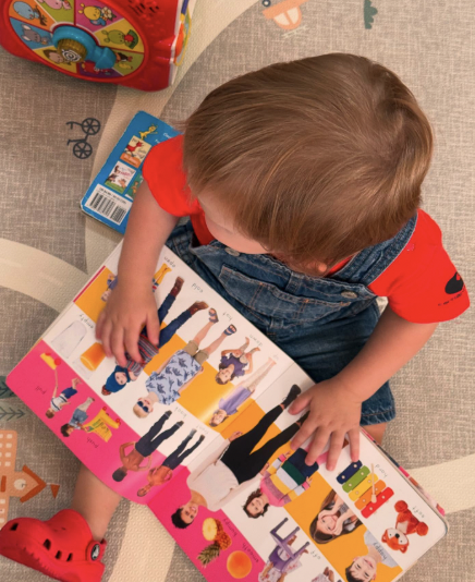 Child enjoying a book at Montessori Playhouse
